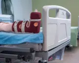 Piede con tutore per prevenire la piaga da decubito sul tallone, appoggiato su un letto ospedaliero.