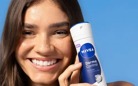 Donna sorridente con prodotto Nivea Derma Control. Soluzione per la dermatite ascellare cura.